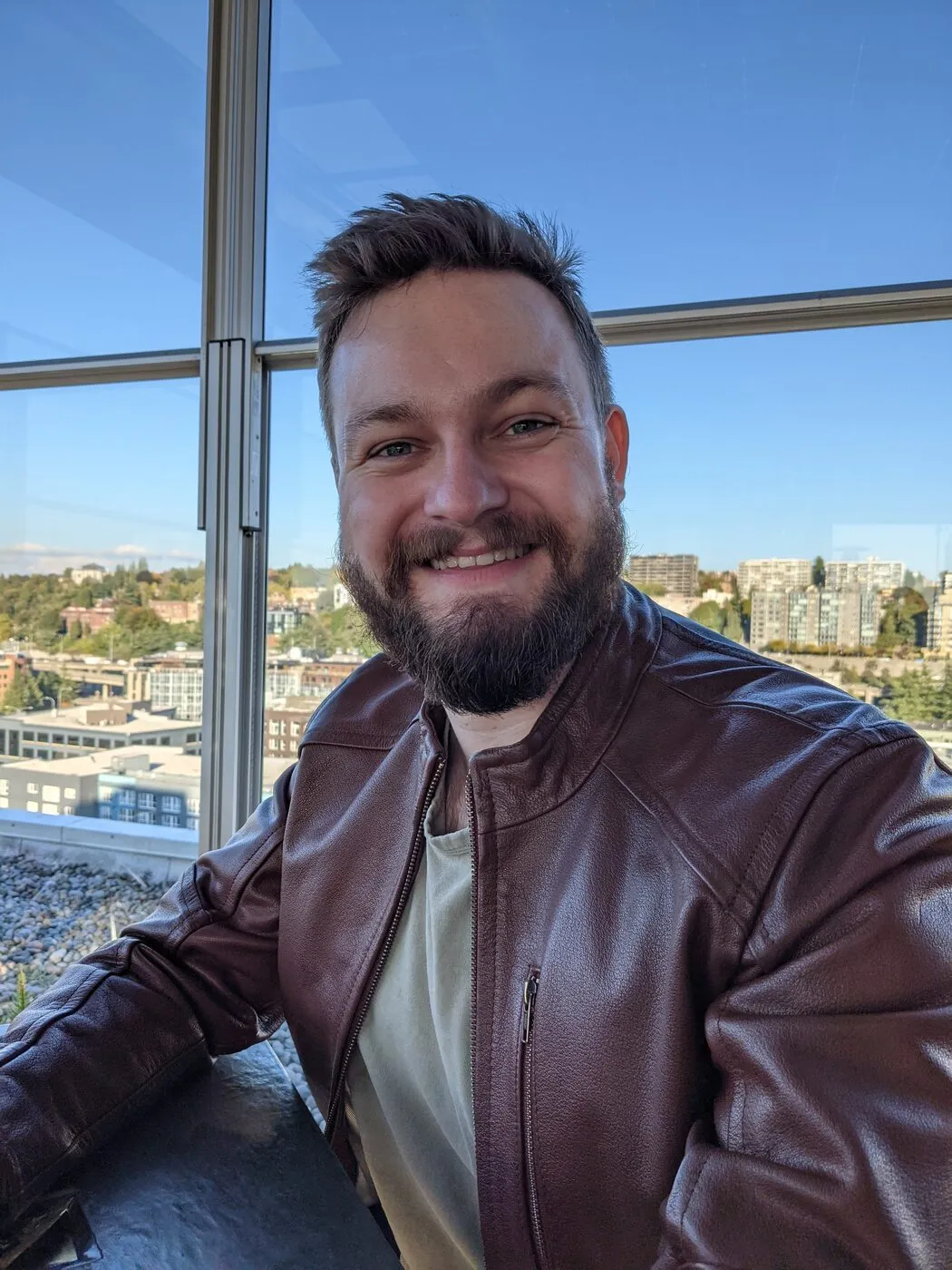 Joseph Bianchi, smiling straight at the camera in a leather jacket.